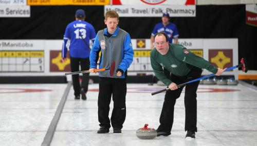 Carberry's Max Vankommer (left) helps Winnipeg's Kevin Thompson guide a rock inbound for the "house" at a community bonspiel held in Carberry annually. Featuring over a hundred teams, the spiel is a success story in the rural curling world. Feb 21, 2013 - (Phil Hossack / Winnipeg Free Press)