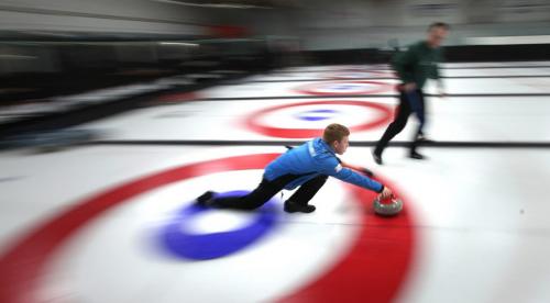 Carberry's Max Vankommer releases his rock as  Winnipeg's Kevin Thompson prepares to sweep  the rock to the "house" at a community bonspiel held in Carberry annually. Featuring over a hundred teams, the spiel is a success story in the rural curling world. Feb 21, 2013 - (Phil Hossack / Winnipeg Free Press)