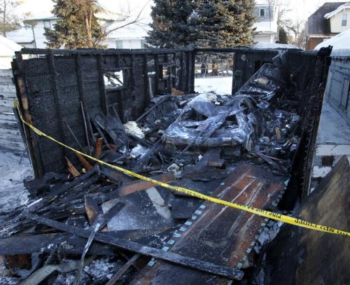 The scene Tuesday morning after an overnight fire destroyed a garage and vehicle behind a home in the 400 block of Anderson Ave. Fire crews responded to the fire that caused an estimated at $25,000 shortly after midnight, no injuries were reported and the cause of the fire is unknown.        (WAYNE GLOWACKI/ WINNIPEG FREE PRESS) WINNIPEG FREE PRESS  Feb.26 2013