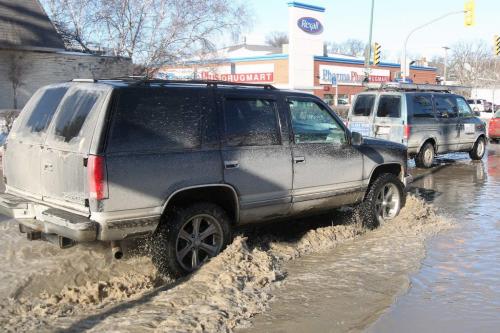 Cars and trucks navigate through high water caused by a watermain break at Corydon and Stafford Ave Tuesday morning  Standup photo- February 26, 2013   (JOE BRYKSA / WINNIPEG FREE PRESS)