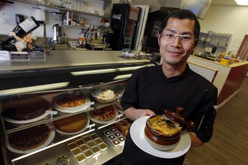 Restaurant review Cafe Ce Soir at 937 Portage Ave. Owner/Pastry Chef Cam Tran poses with some french onion soup in front of the desert cooler display. Feb 26, 2013  BORIS MINKEVICH / WINNIPEG FREE PRESS