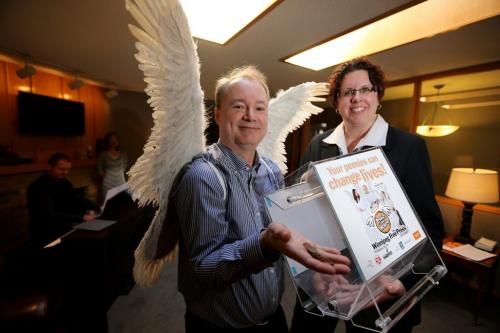 Kevin Rollason with Lynette Lafreni¾®re Buchanan, Funeral Director at Desjardins Funeral Homes, where an event was held to collect pennies for the Pennies from Heaven campain, Wednesday, February 27, 2013. (TREVOR HAGAN/WINNIPEG FREE PRESS)