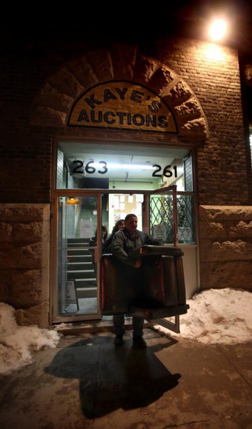 FOR BUSINESS -  Frank Dyck, takes a leather chair purchased at a weekly Thursday night auction at Kaye's out to his waiting vehicle before returning to bid on more...See Randy Turner's story. Feb 28, 2013 - (Phil Hossack / Winnipeg Free Press)