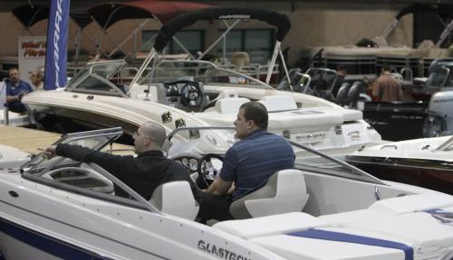 Sylvain Laporte helps Kris Hansen decide what boat he should check out during the 2013 Mid Canada Boat Show at the Winnipeg Convention Centre, Friday, March 1, 2013. (TREVOR HAGAN/WINNIPEG FREE PRESS)