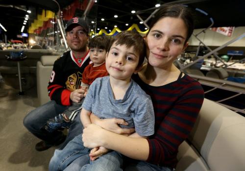 Brian Chartrand, with his sons Banx, 3, and Noah, 6, and Sarah Stewart in the 22 foot fish and ski pontoon boat they bought while at the 2013 Mid Canada Boat Show at the Winnipeg Convention Centre, Friday, March 1, 2013. (TREVOR HAGAN/WINNIPEG FREE PRESS)