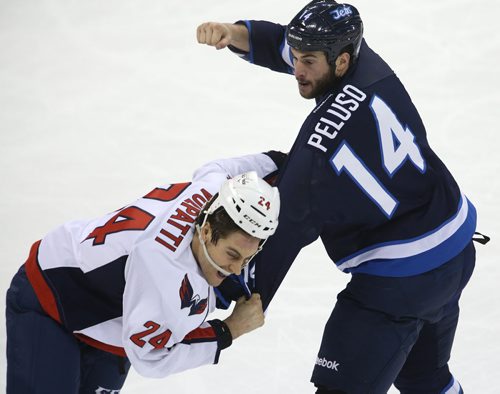 Winnipeg Jets' Anthony Peluso (14) fights with Washington Capitals' Aaron Volpatti (24) late in the first period of NHL hockey action at MTS Centre in Winnipeg, Saturday, March, 2, 2013. (TREVOR HAGAN/WINNIPEG FREE PRESS)