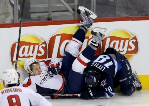 Washington Capitals' John Carlson (74) ends up on top of Winnipeg Jets' Bryan Little (18) after they got tangled up in the first period of NHL hockey action at MTS Centre in Winnipeg, Saturday, March, 2, 2013. (TREVOR HAGAN/WINNIPEG FREE PRESS)