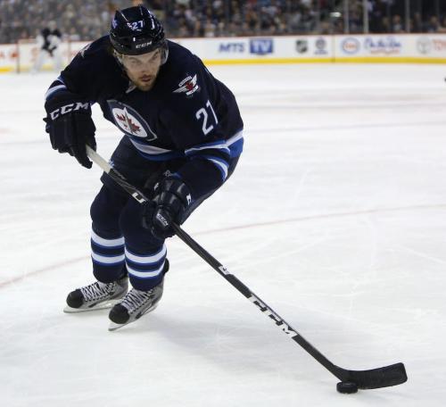 Winnipeg Jets' Eric Tangradi (27) carries the puck during the second period of NHL hockey against the Washington Capitals' at MTS Centre, Saturday, March 2, 2013. (TREVOR HAGAN/WINNIPEG FREE PRESS)