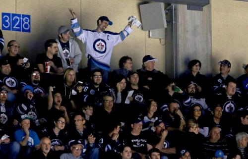 Carlos Labao, top, reacts after not winning the 50-50 as the Winnipeg Jets' faced the Washington Capitals' during NHL hockey action at MTS Centre, Saturday, March 2, 2013. He had won on two previous occasions. (TREVOR HAGAN/WINNIPEG FREE PRESS)