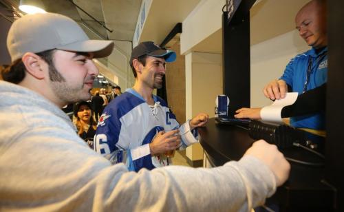 Carlos Labao, middle, purchasing a 50/50 ticket after winning on two previous occasions. His friend, Gio DiNoto, left, hoped today the two could share in the spoils. The pair were watching as the Winnipeg Jets' faced the Washington Capitals' during NHL hockey action at MTS Centre, Saturday, March 2, 2013. (TREVOR HAGAN/WINNIPEG FREE PRESS)