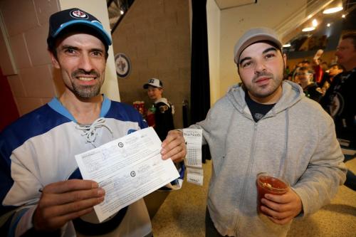 Carlos Labao, holding two winning 50/50 tickets. His friend, Gio DiNoto, right, hoped today the two could share in the spoils. The pair were watching as the Winnipeg Jets' faced the Washington Capitals' during NHL hockey action at MTS Centre, Saturday, March 2, 2013. (TREVOR HAGAN/WINNIPEG FREE PRESS)