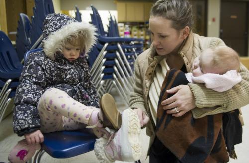 030213 Winnipeg-   Miranda helps her daughter Faith (3 years old) try on a pair of shoes as she holds her other daughter Olive at The North End Family Centre, as it hosted ÄúThe Great Clothing GiveawayÄù  Saturday afternoon at St. JohnÄôs Cathedral. DAVID LIPNOWSKI / WINNIPEG FREE PRESS