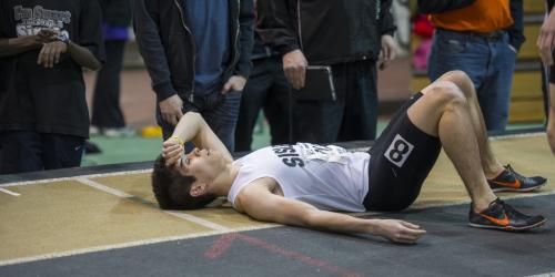 030213 Winnipeg-  Brendan Cuaresma lies on the ground exhausted after running the junior 800M mens race at the 32nd Annual Boeing Indoor Classic Tracking and Field Meet at the Max Bell Centre at The University of Manitoba Saturday. DAVID LIPNOWSKI / WINNIPEG FREE PRESS