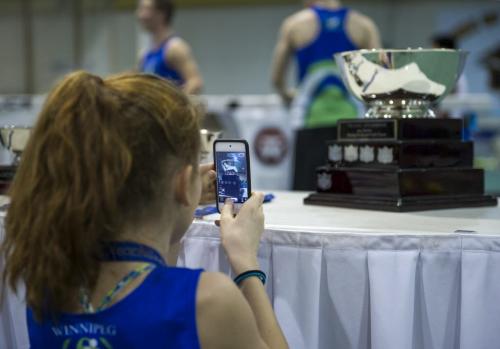 030213 Winnipeg-  A young competitor takes a photo of awards during the 32nd Annual Boeing Indoor Classic Tracking and Field Meet at the Max Bell Centre at The University of Manitoba Saturday. DAVID LIPNOWSKI / WINNIPEG FREE PRESS