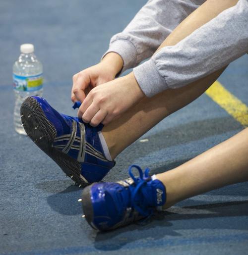 030213 Winnipeg-  A competitor ties her shoe laces during the 32nd Annual Boeing Indoor Classic Tracking and Field Meet at the Max Bell Centre at The University of Manitoba Saturday. DAVID LIPNOWSKI / WINNIPEG FREE PRESS