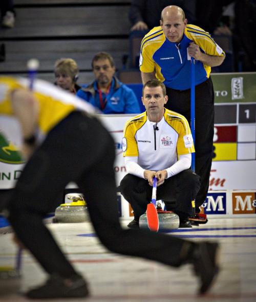 Alberta skip Kevin Martin watches from behind Manitoba skip Jeff Stoughton during their game at the Canadian Men's Curling Championships in Edmonton, Alberta March 2, 2013.   REUTERS/Andy Clark    (CANADA - Tags: SPORT CURLING) - RTR3EI5S