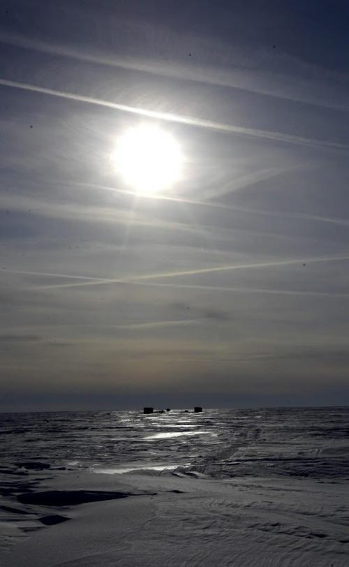 Sun shines over the East side of Lake Winnipeg just south of Grand Beach, Manitoba. On horizon is a some ice fishing shacks. Feb 20, 2013  BORIS MINKEVICH / WINNIPEG FREE PRESS