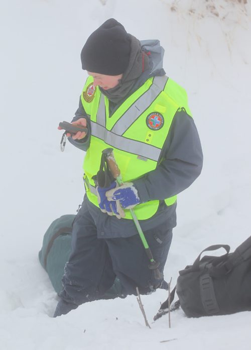 Brandon Sun Playing the role of a wandering crash victim, GSAR volunteerBeckey Stewart marks the crash site on her GPS unit before heading off away from the crash site. (Bruce Bumstead/Brandon Sun)
