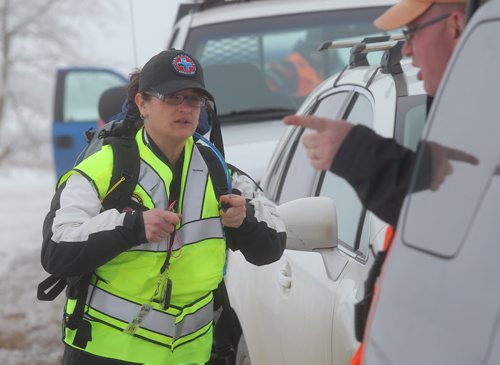 Brandon Sun GSAR members gear up at the roadside to search for victims of a mock plane crash northeast of Forrest, Man., on Sunday morning. (Bruce Bumstead/Brandon Sun)
