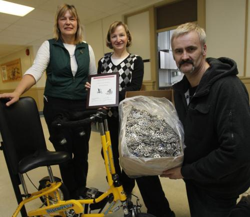 From right to left, George Klassen holds just a small amount of the beverage tabs his late sister Barbara Klassen collected,he is donating them to the Seven Oaks School Division Tab Collection Program to go towards the purchase a specialty trike similar to one in the photo for a student in the Seven Oaks School Division.On behalf of the Seven Oaks School Division Tab Collection Program committee is Carol Anandranistakis, the Secretary at Victory School holding a certificate of thanks to George and Sandy Loewen,Physiotherapist, Rehabilitation Centre for Children. Steph Crosier story.WAYNE GLOWACKI/ WINNIPEG FREE PRESS) WINNIPEG FREE PRESS  March 6 2013