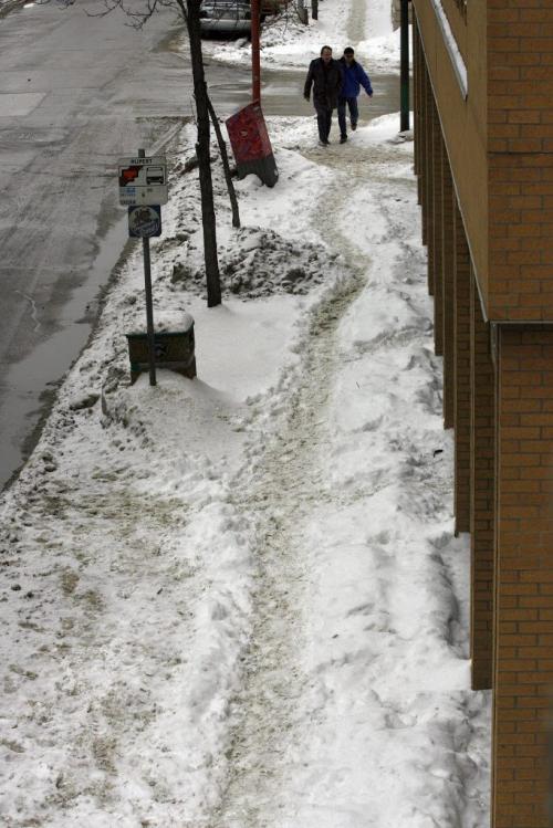 King St  near Rupert Ave pedestrian  on a narrow path  on sidewalk -Walking the Slippery Walk  in downtown Wpg , unploughed  sidewalks , slushy  snow conditions making walking difficult after the large snow fall of the past week Äì gordon sinclair story - KEN GIGLIOTTI / Mar. 6 2013 / WINNIPEG FREE PRESS