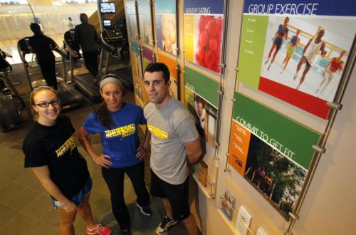 Fitness column. Certified personal trainers at the Wellness Institute are from right,  Tim Shantz, Alex Nataluk and Ashley Derlago by a display  of programs offered.  WAYNE GLOWACKI/ WINNIPEG FREE PRESS) WINNIPEG FREE PRESS  March 6 2013