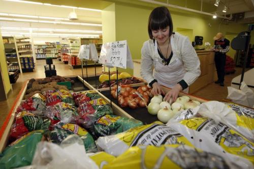 Grocery clerk Zorya Arrow  stocks vegetable display - Neechi Commons Community Business Complex  - prepare for   grand opening March 19 , the Commons food store is open for business  but the sheleve are fully stocked Äì Murray McNeill story -  KEN GIGLIOTTI / Mar. 6 2013 / WINNIPEG FREE PRESS