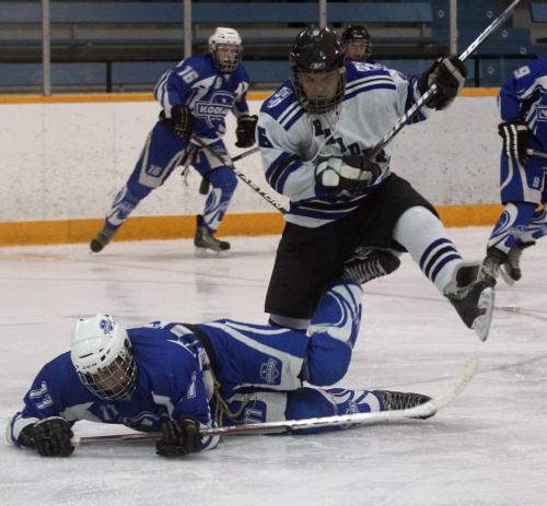River East Kodiaks Lucas Henry, left, gets crushed  by Oak Park Raiders  Jeremy Hope during third period action Friday night at the AAAA Provincial High School Hockey Championships at the St James Civic Centre  See Tim Campbell story- March 08, 2013   (JOE BRYKSA / WINNIPEG FREE PRESS)