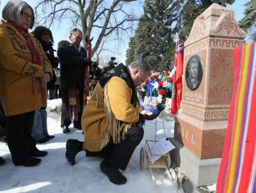 Manitoba M¾©tis Federation president David Chartrand leaves a copy of the Supreme Court ruling in favour of the M¾©tis people versus the federal government at the gravesite of M¾©tis leader Louis Riel at the St. Boniface Cathedral Cemetery on Sat., March 9, 2013. On March 8, 2013, the Supreme Court ruled the federal government was "ineffectual and inequitable" in how it handed out land to M¾©tis children in Manitoba more than 130 years ago. Photo by Jason Halstead/Winnipeg Free Press