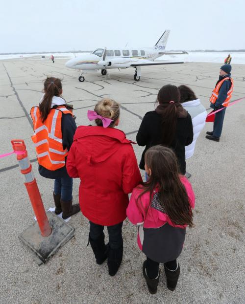 A group of women wait to board a Missinippi Airways Piper Navajo Chieftain aircraft at the ÄúWomen FlyÄù International WomenÄôs Day event at St. Andrews Airport north of Winnipeg, on on Sat., March 9, 2013. Photo by Jason Halstead/Winnipeg Free Press