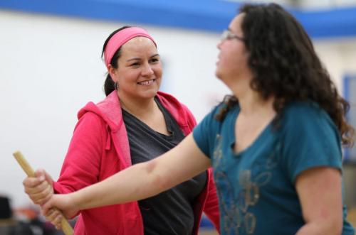 Christine Cyr, left, playing an Inuit Wrestling game with Michelle Carriere. Christine Cyr who recently received the education award from Future Leaders of Manitoba, at Southeast Collegiate with an instructor teaching about Traditional Aboriginal Sports And Games.  Saturday, March 9, 2013. (TREVOR HAGAN/WINNIPEG FREE PRESS) - volunteer column