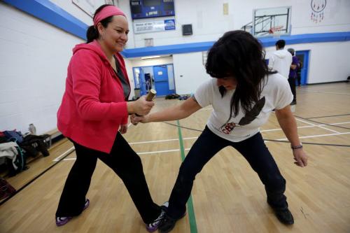Christine Cyr, left, playing an Inuit Wrestling game with Kali Storm. Christine Cyr who recently received the education award from Future Leaders of Manitoba, at Southeast Collegiate with an instructor teaching about Traditional Aboriginal Sports And Games.  Saturday, March 9, 2013. (TREVOR HAGAN/WINNIPEG FREE PRESS) - volunteer column