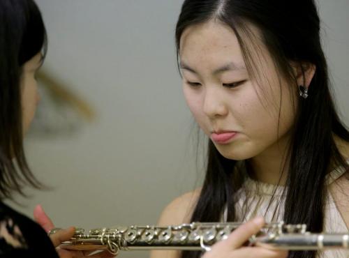 Jaena Kim, right, examines her flute while waiting to perform at the Aikins Memorial Trophy Competition at the Winnipeg Art Gallery, Saturday, March 9, 2013. (TREVOR HAGAN/WINNIPEG FREE PRESS) - for tuesday music page