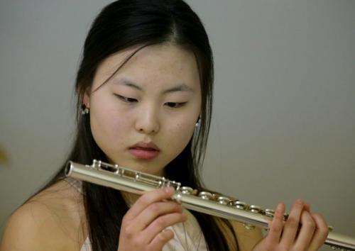 Jaena Kim examines her flute while waiting to perform at the Aikins Memorial Trophy Competition at the Winnipeg Art Gallery, Saturday, March 9, 2013. (TREVOR HAGAN/WINNIPEG FREE PRESS) - for tuesday music page