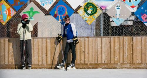 Whitney Klaassen (left) and Rebecca Atkinson wait for a shift change during a pickup game of hockey at the outdoor rink behind Broadway Neighbourhood Centre on Sunday afternoon. (Melissa Tait / Winnipeg Free Press)