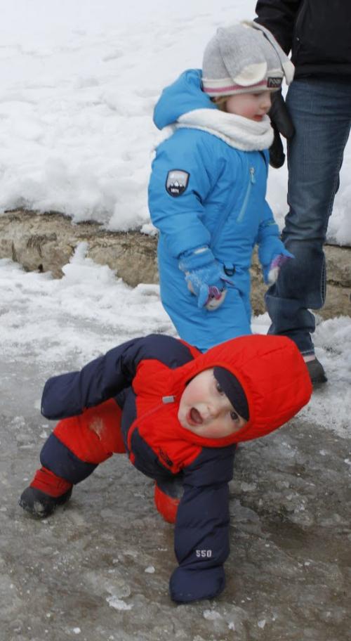 Eighteen-month old Tyrus (foreground) navigates the icy Riverwalk at The Forks with his friend Olivia, age 2, with their mothers Monday morning. (JESSICA BURTNICK/WINNIPEG FREE PRESS) March 11, 2013