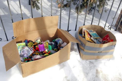 MYSTERY BOXES - Some boxes of abandoned toys and books lay near the sidewalk on Stradbrook Ave.  The box appeared out of nowhere and some homeless people were seen going through them but nothing was taken apparently. March 12, 2013  BORIS MINKEVICH / WINNIPEG FREE PRESS