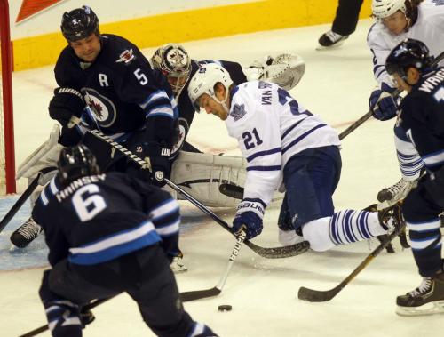 Maple Leaf's #21 James van Riemsdyk fights for control in front of the Winnipeg Jets netminder Ondrej Pavelec and defenceman #5 Mark Stuart Monday night at the MTS Center in 1st period action. March 13, 2013 - (Phil Hossack / Winnipeg Free Press)