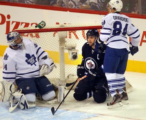 Winnipeg Jet Captain Andrew Ladd peers out from inside the leaf's net behind goalie James Reimer and cetner Mikhail Grabovski after a failed 2 on 1 rush Monday night at the MTS Center in 1st period action. March 13, 2013 - (Phil Hossack / Winnipeg Free Press)