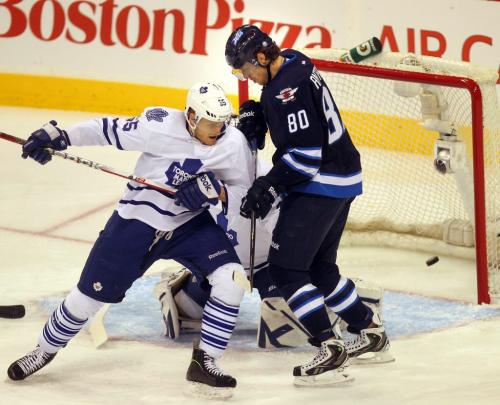 A deflected puck slides into the Maple LEaf's net off Nik Andropov's stick despite the defensive efforts of defensman Mark Fraser Monday night at the MTS Center in 1st period action. March 13, 2013 - (Phil Hossack / Winnipeg Free Press)