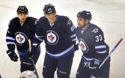 Winnipeg Jet Nik Andropov (center and Dustin Byfuglien skate off with Kyle Wellwood after Andropov's goal assisted by Byfuglien opened the scoring Monday night at the MTS Center in 1st period action. March 13, 2013 - (Phil Hossack / Winnipeg Free Press)