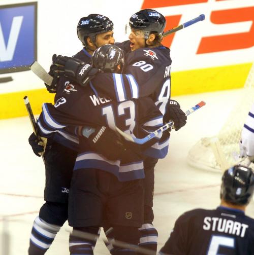Winnipeg Jets Dustin Byfuglien, Niik Andropv and Kyle Wellwood celebrate Wellwoods goal, 3rd for the team against the Leafs. Monday night at the MTS Center's 2nd period. March 13, 2013 - (Phil Hossack / Winnipeg Free Press)