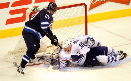 Winnipeg JetNik Andropov tries to stuff a puck through  Maple LEaf #55 Korbinian Holzer and netminder James Reimer Monday night at the MTS Center's 2nd period. March  13, 2013 - (Phil Hossack / Winnipeg Free Press)