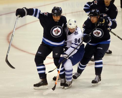 Toronto Maple Leaf #84 Mikhail Grabovski finds the going tough between Winnipeg Jets #5 Mark Stuart and #20 Antti Miettinen in the third period in Winnipeg's MTS Center Tuesday night. March 12, 2013 - (Phil Hossack / Winnipeg Free Press)