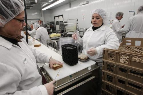Diet Aids Wendy Mieyette (left) and Karina Cabezas (right) put the finishing touches on the egg salad sandwiches during a tour of the Regional Distribution Facility at the WRHA Nutrition and Food Services Centre at 345 De Baets Street in St. Boniface.  130312 - Tuesday, March 12, 2013 -  (MIKE DEAL / WINNIPEG FREE PRESS)