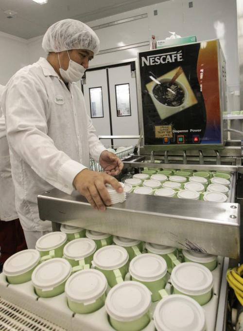 Romeo Valencia a Diet Aid, prepares trays of coffee cups during a tour of the Regional Distribution Facility at the WRHA Nutrition and Food Services Centre at 345 De Baets Street in St. Boniface.  130312 - Tuesday, March 12, 2013 -  (MIKE DEAL / WINNIPEG FREE PRESS)
