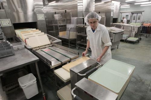 Angela Thiessen takes clean trays out of the tray washing machine during a tour of the Regional Distribution Facility at the WRHA Nutrition and Food Services Centre at 345 De Baets Street in St. Boniface.  130312 - Tuesday, March 12, 2013 -  (MIKE DEAL / WINNIPEG FREE PRESS)