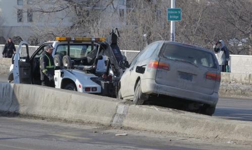 A van got stuck on the medium at the north side on the Osborne St. Bridge. MVC. MVA. No other information. March 14, 2013  BORIS MINKEVICH / WINNIPEG FREE PRESS