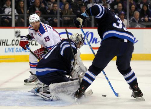 Winnipeg Jet Netminder Ondrej Pavelec and defenceman Dustin Byfuglien keep an attempt by New York Ranger Brad Richards # 19 from between the pipes in the first period at the MTS Center Thursday night. March 14, 2013 - (Phil Hossack / Winnipeg Free Press)