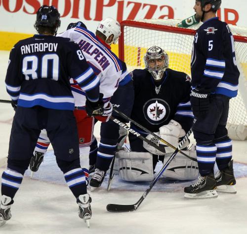 Winnipeg Jet Netminder Ondrej Pavelec looks up to defenceman Mark Stuart (#5) after making a save in the second period at the MTS Center Thursday night. March 14, 2013 - (Phil Hossack / Winnipeg Free Press)